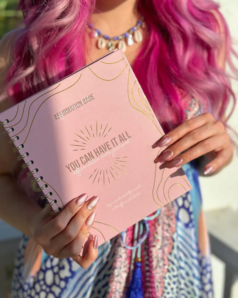 Ashley holding the You Can Have It All journal