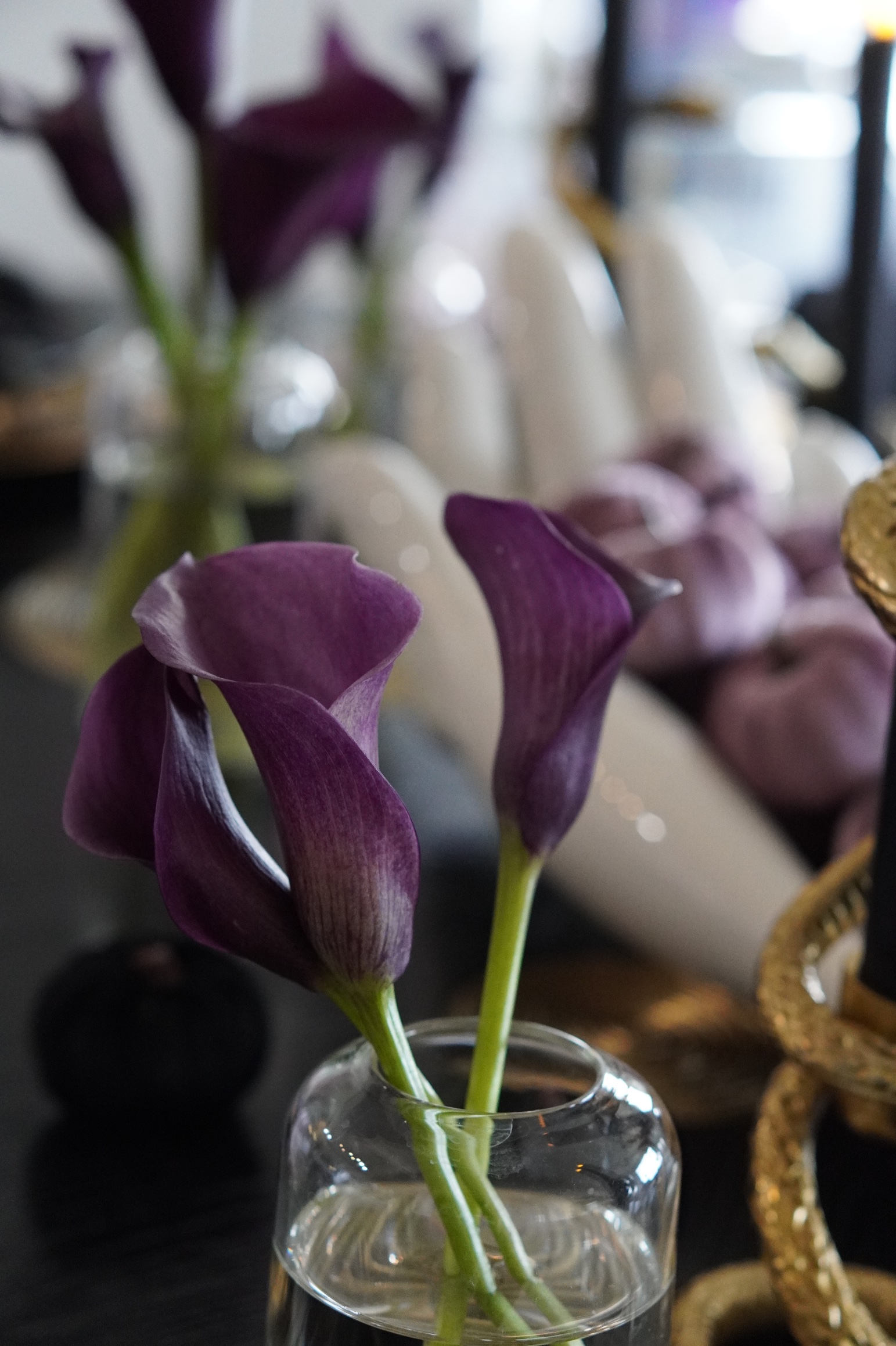 Deep purple calla lilies in a bud vase on the Galloween table
