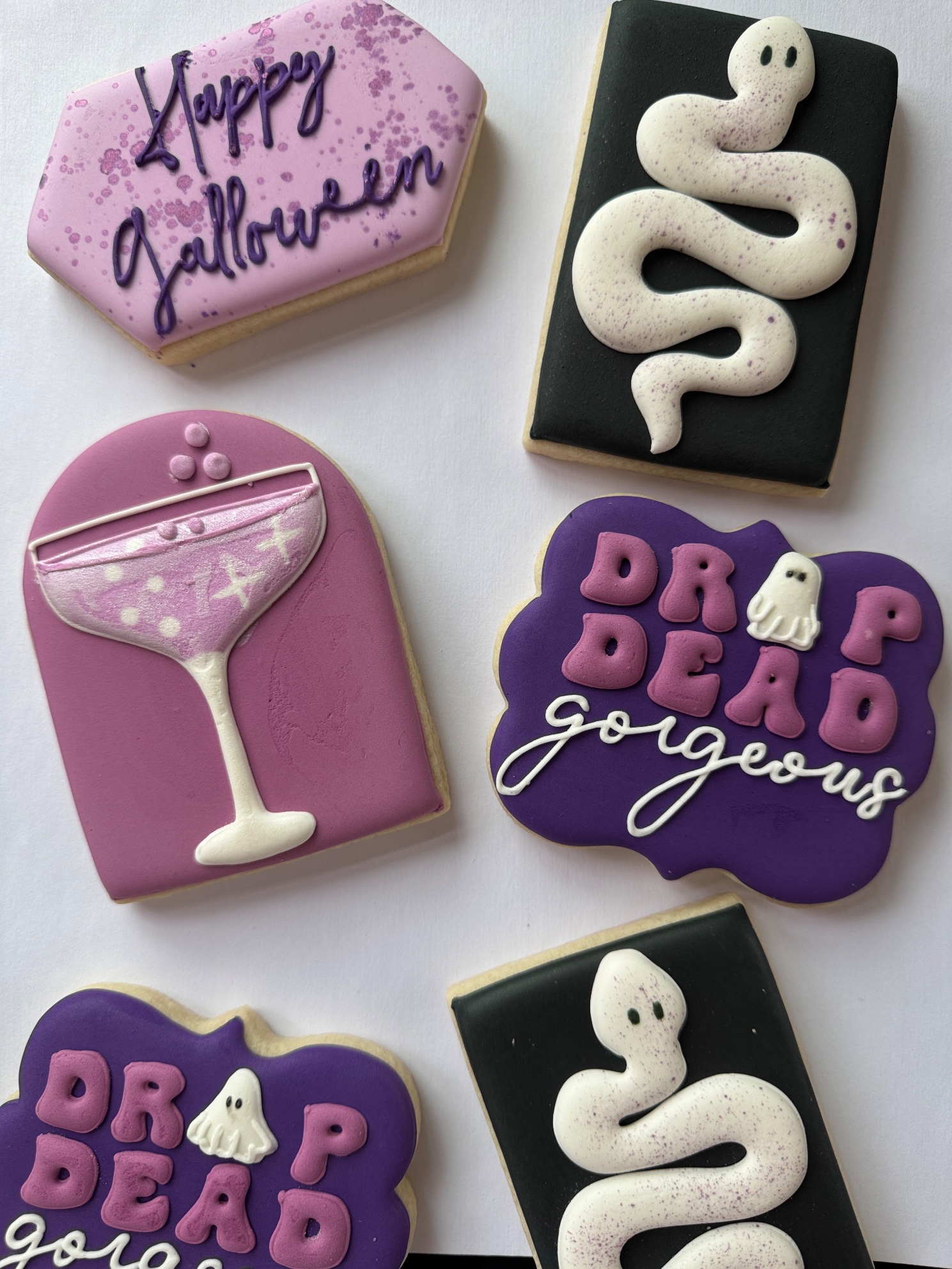 Close-up of the custom Galloween cookies: Happy Galloween, a white snake, a martini glass and Drop Dead Gorgeous
