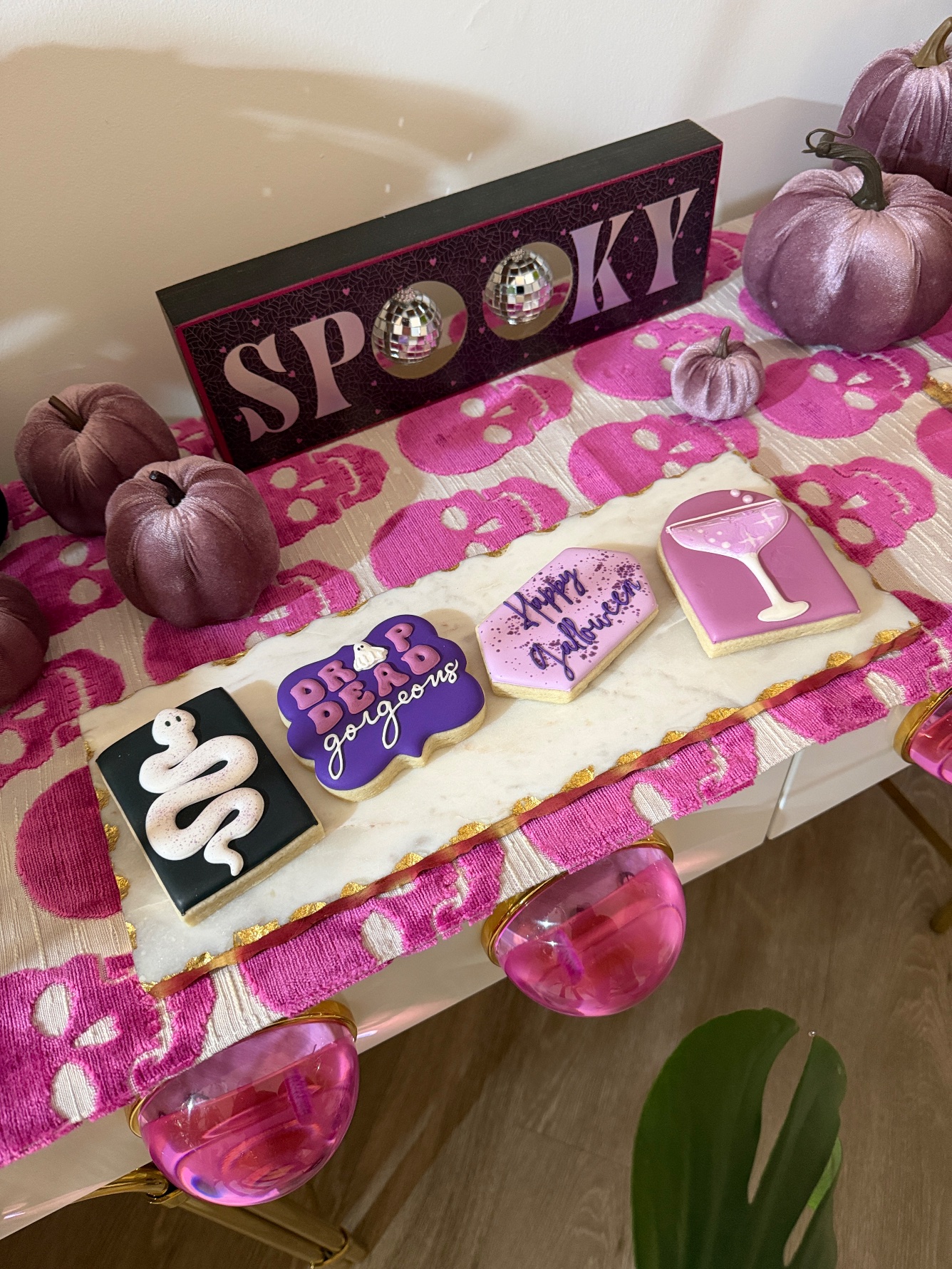Custom Galloween cookies - snake, martini glass, Happy Galloween and Drop Dead Gorgeous - on a pink skull table runner