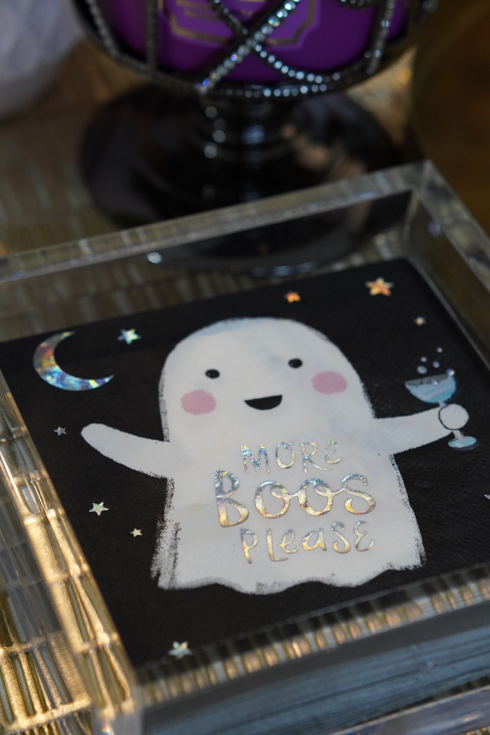 'More Boos Please' ghost cocktail napkin in an acrylic holder