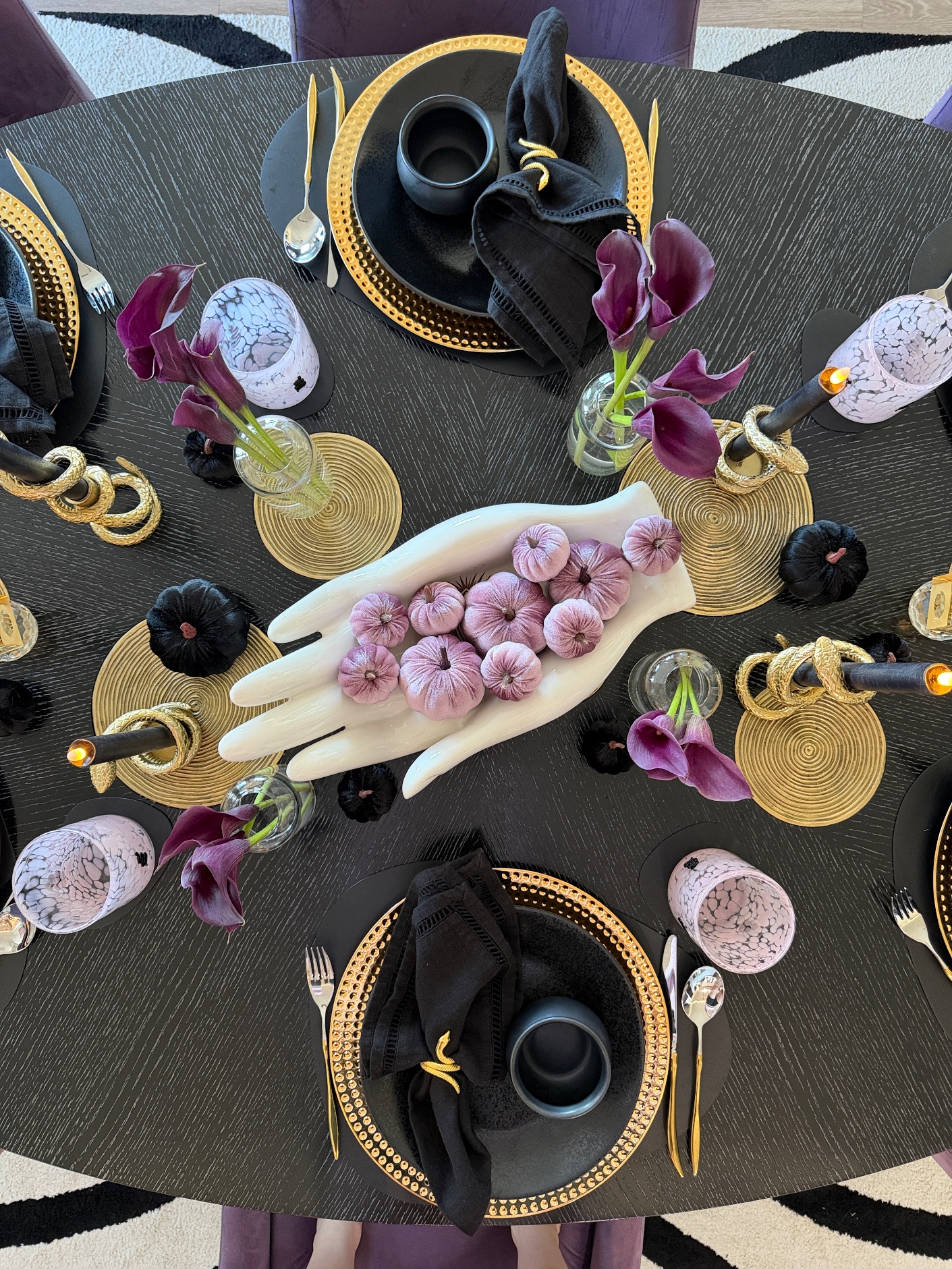 Overhead view of the round Galloween table with the hand bowl of lilac velvet pumpkins at the center