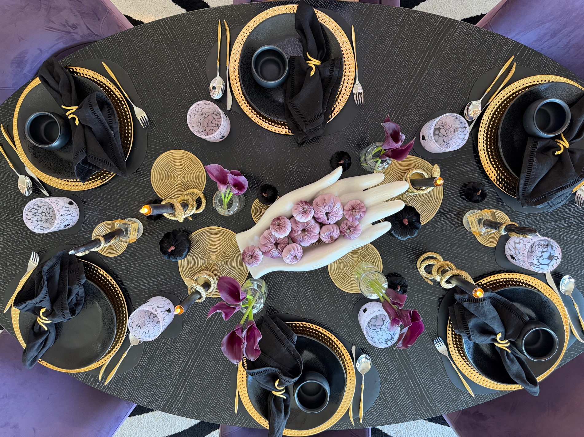 Overhead view of the oval Galloween table set in purple, black and gold