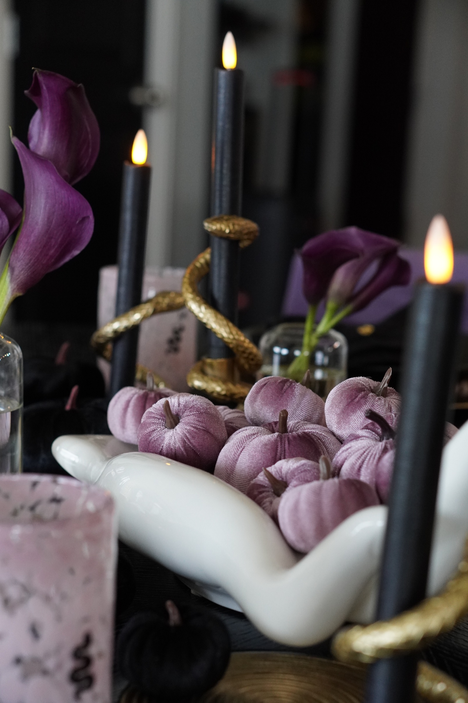 Lilac velvet pumpkins in the white hand bowl with gold snake candle holders, black tapers and purple calla lilies