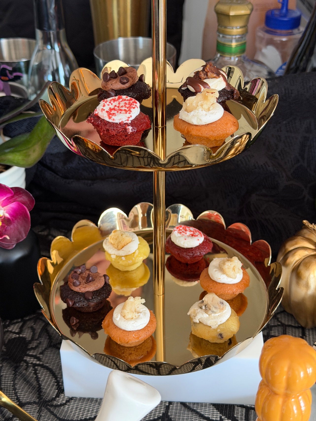 Baked by Melissa mini cupcakes on a gold two-tier scalloped stand