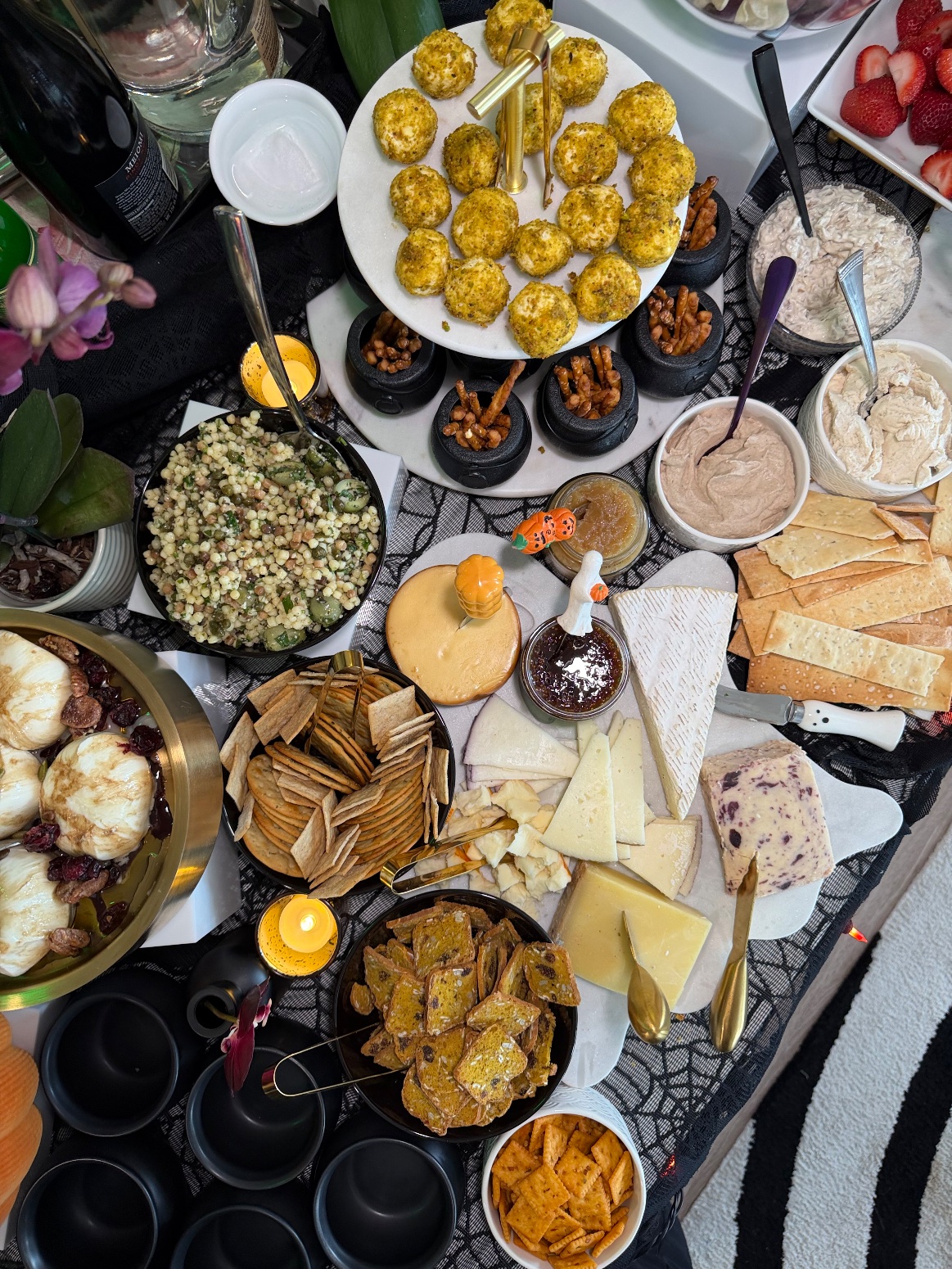 Overhead view of the Galloween grazing table with the cheese board, mini cheese balls, dips, fregola salad and burrata