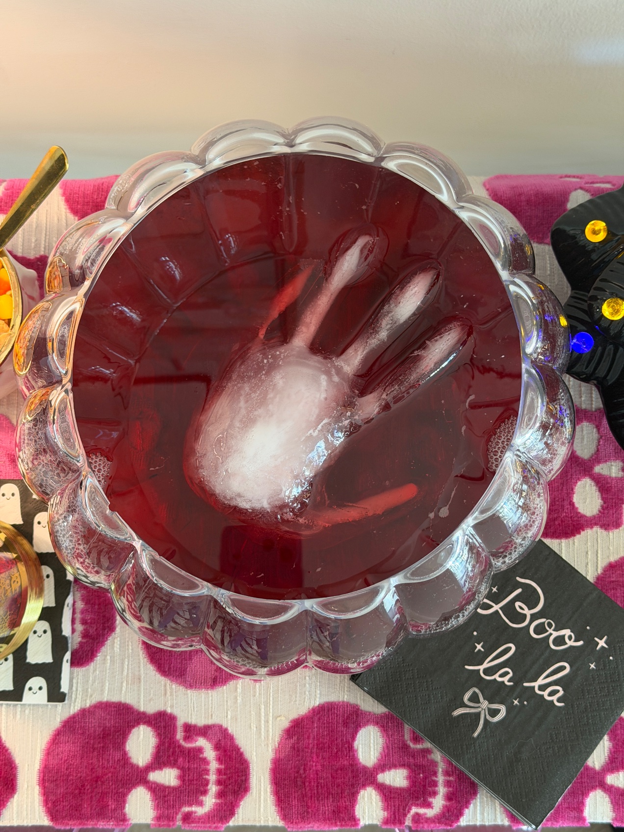 The Galloween punch bowl from above, cranberry pomegranate punch with a frozen ice hand floating in it