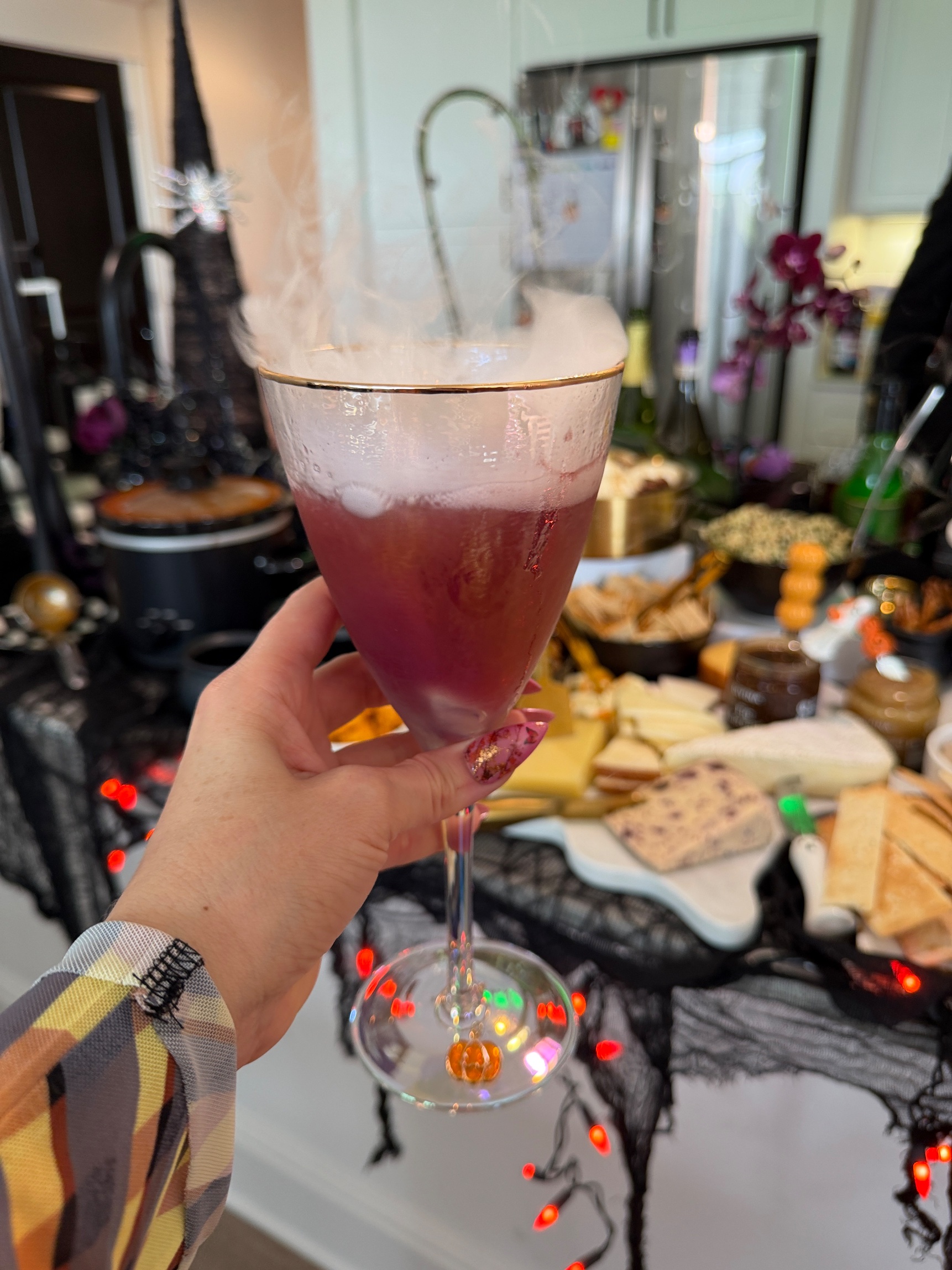 Smoking pink punch in an iridescent goblet with a little pumpkin charm on the stem