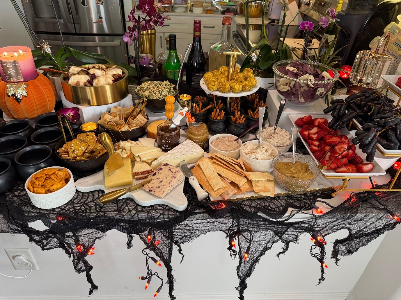 The grazing table head on: burrata, fregola salad, mini cheese balls, ghost chips, moon grapes, strawberries and figs