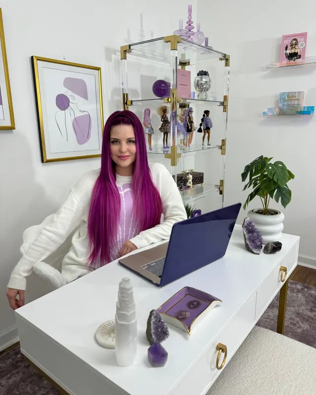 Ashley at her white desk in her office today