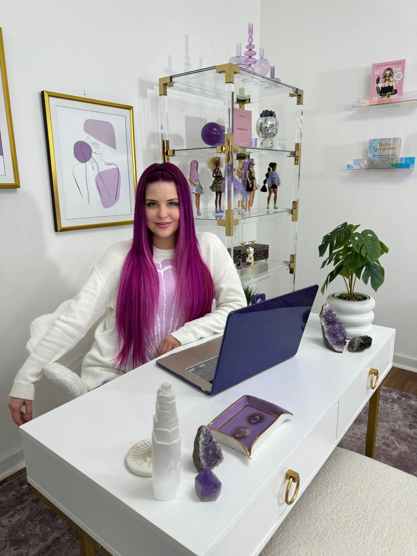 Ashley at her white desk in her office today